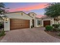 Charming home featuring a brick driveway, three car garage, and well-maintained landscaping at 7511 S Parkcrest St, Gilbert, AZ 85298