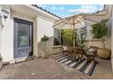 Cozy outdoor patio with table, chairs, umbrella, and decorative plants, ideal for relaxing at 7511 S Parkcrest St, Gilbert, AZ 85298