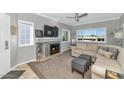 Inviting living room featuring a cozy fireplace, neutral decor, and bright windows at 7710 E Gainey Ranch Rd # 206, Scottsdale, AZ 85258