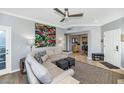 Open-concept living room flowing into the kitchen with comfortable seating and natural light at 7710 E Gainey Ranch Rd # 206, Scottsdale, AZ 85258