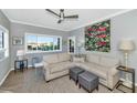 Comfortable living room with large windows, a ceiling fan, and stylish decor at 7710 E Gainey Ranch Rd # 206, Scottsdale, AZ 85258