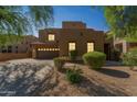 Southwest-style home showcasing desert landscaping, a spacious driveway, and a two-car garage at 8503 W Coyote Dr, Peoria, AZ 85383