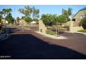Community entry gate with brick-paved road and lush desert landscaping at 1015 S Val Vista Dr # 8, Mesa, AZ 85204