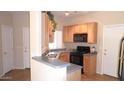 Cozy kitchen featuring essential appliances and light wood cabinetry at 1015 S Val Vista Dr # 8, Mesa, AZ 85204