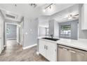 The kitchen has quartz countertops, stainless steel appliances, and wood look tile flooring at 11375 E Sahuaro Dr # 1008, Scottsdale, AZ 85259
