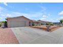 Charming single-story home featuring a two-car garage and low-maintenance desert landscaping at 12029 N 44Th Dr, Glendale, AZ 85304