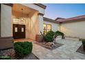 Welcoming front entrance featuring a covered doorway, manicured landscaping, and a well-lit walkway at 16238 N 58Th St, Scottsdale, AZ 85254