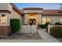 Beautiful home entrance with a meticulously maintained yard and covered doorway creating curb appeal at 16238 N 58Th St, Scottsdale, AZ 85254