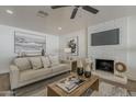 Cozy living room featuring a white brick fireplace and comfortable neutral-toned furniture at 16421 N 34Th Ave, Phoenix, AZ 85053