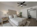 Serene main bedroom showcasing a tufted headboard and contemporary décor at 16421 N 34Th Ave, Phoenix, AZ 85053