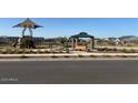 Community park featuring a playground and covered picnic area for residents to enjoy at 17758 W Odeum Ln, Goodyear, AZ 85338