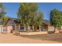 Quaint single-story home with mature trees, a two-car garage, and a large driveway at 19407 N 15Th Ave, Phoenix, AZ 85027