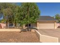 Charming single-story home with a two-car garage, neutral colors, and mature landscaping at 19407 N 15Th Ave, Phoenix, AZ 85027