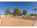 Quaint single-story home with mature trees, a two-car garage, and a large driveway at 19407 N 15Th Ave, Phoenix, AZ 85027