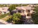 Charming two-story home featuring lush landscaping, a spacious driveway, and a welcoming facade at 2109 W Wildhorse Dr, Chandler, AZ 85286