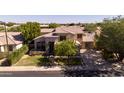 Inviting two-story home with a well-manicured lawn and mature trees creating a picturesque curb appeal at 2109 W Wildhorse Dr, Chandler, AZ 85286