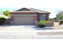 Single-story home featuring a two-car garage and desert landscaping at 21433 E Calle De Flores Ct, Queen Creek, AZ 85142