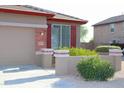 Single-story home featuring a two-car garage and desert landscaping at 21433 E Calle De Flores Ct, Queen Creek, AZ 85142