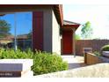 Well-maintained home with desert landscaping and a welcoming red front door at 21433 E Calle De Flores Ct, Queen Creek, AZ 85142