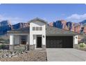 Inviting single-story home featuring a neutral color palette, attached garage, and desert landscaping at 2317 S 125Th Dr, Avondale, AZ 85323