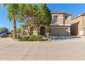 Charming home featuring a well-maintained front yard, neutral stucco exterior, arched entry, and convenient two-car garage at 3064 E Michelle Way, Gilbert, AZ 85234