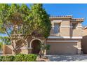 Inviting home featuring a well-maintained front yard, neutral stucco exterior, arched entry, and convenient two-car garage at 3064 E Michelle Way, Gilbert, AZ 85234