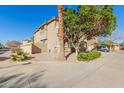 Beautifully landscaped home featuring a neutral stucco exterior, arched entry, and convenient two-car garage at 3064 E Michelle Way, Gilbert, AZ 85234