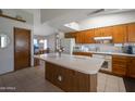 Spacious kitchen with a functional island, ample cabinet space, and a view into the adjacent dining area at 3227 W Kristal Way, Phoenix, AZ 85027
