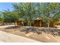 Charming single-story home with mature trees providing shade in the front yard at 3842 W Ocotillo Rd, Phoenix, AZ 85019
