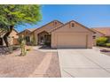 Charming single-story home with a desert landscape, a neutral color palette, and a two-car garage at 4037 E Milton Dr, Cave Creek, AZ 85331