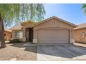 Charming single-story home featuring a neutral color palette, low-maintenance landscaping, and an attached two-car garage at 7310 N 68Th Ln, Glendale, AZ 85303