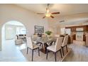 Open-concept dining area with modern light fixture, leading into the living room and kitchen spaces at 742 S Rose --, Mesa, AZ 85204