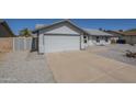A clean-lined single-story home featuring a two-car garage and a low-maintenance, desert-landscaped front yard at 742 S Rose --, Mesa, AZ 85204