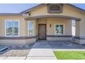 Inviting front entrance with a decorative security door, modern windows, and manicured landscaping at 8541 W Sierra Vista Dr, Glendale, AZ 85305