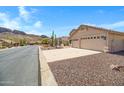 Appealing single-story home with desert landscaping, set against a backdrop of beautiful mountain views at 10214 E Moonshadow Way, Gold Canyon, AZ 85118