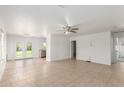 Spacious living room with tile flooring, ceiling fan, and a view of the backyard at 10521 W Donald Dr, Peoria, AZ 85383