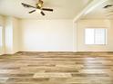 Bright living room featuring wood flooring and large windows at 10722 W Quartz Dr, Casa Grande, AZ 85193
