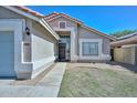 Inviting front exterior with a well-maintained lawn, pathway to the front door, and a two-car garage at 11224 W Puget Ave, Peoria, AZ 85345