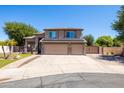 Inviting two-story home with a large driveway, three-car garage, desert landscaping, and solar panels at 1204 S Arroya Cir, Mesa, AZ 85206