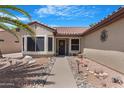 Home exterior featuring a charming entrance with desert landscaping and a cozy bench at 15971 W Indigo Ln, Surprise, AZ 85374