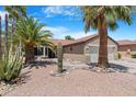 Charming home showcasing desert landscaping with gravel, cacti, and a two-car garage at 15971 W Indigo Ln, Surprise, AZ 85374
