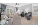 Bright living room with neutral colors, tile flooring, and lots of natural light at 15971 W Indigo Ln, Surprise, AZ 85374