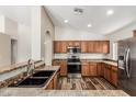 Well-lit kitchen featuring stainless steel appliances, and wood cabinets at 16333 W Paradise Ln, Surprise, AZ 85388