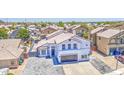 Charming two-story home featuring a meticulously paved driveway and an attached two-car garage at 1853 N Rowen Cir, Mesa, AZ 85207