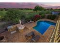Aerial view of a private pool and patio area, complete with an outdoor kitchen and lounge chairs at 1935 E Seminole Dr, Phoenix, AZ 85022