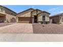 Inviting one-story home featuring desert landscaping, a brick driveway, and a convenient two-car garage at 226 E Monza Way, San Tan Valley, AZ 85140