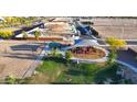 Community playground aerial view showcasing colorful equipment, a covered picnic area, and a sand volleyball court at 2325 S 125Th Dr, Avondale, AZ 85323