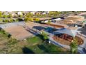 Aerial shot of a community park with playground, sand volleyball court, green spaces, and walking paths at 2325 S 125Th Dr, Avondale, AZ 85323