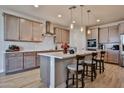 Modern kitchen with stylish island, pendant lighting, stainless steel appliances, and tile backsplash at 29408 N 224Th Dr, Wittmann, AZ 85361
