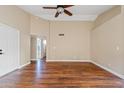 Bright living room featuring wood floors, a ceiling fan and neutral paint at 5734 W Commonwealth Pl, Chandler, AZ 85226